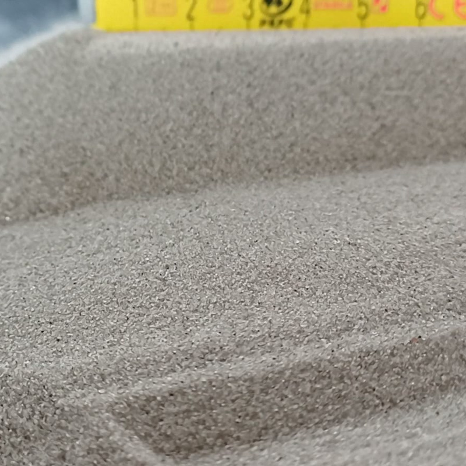 Fugensand Naturgrau, 0,1–0,4 mm, 25 kg: Mulde mit Maßstab im Hintergrund.
