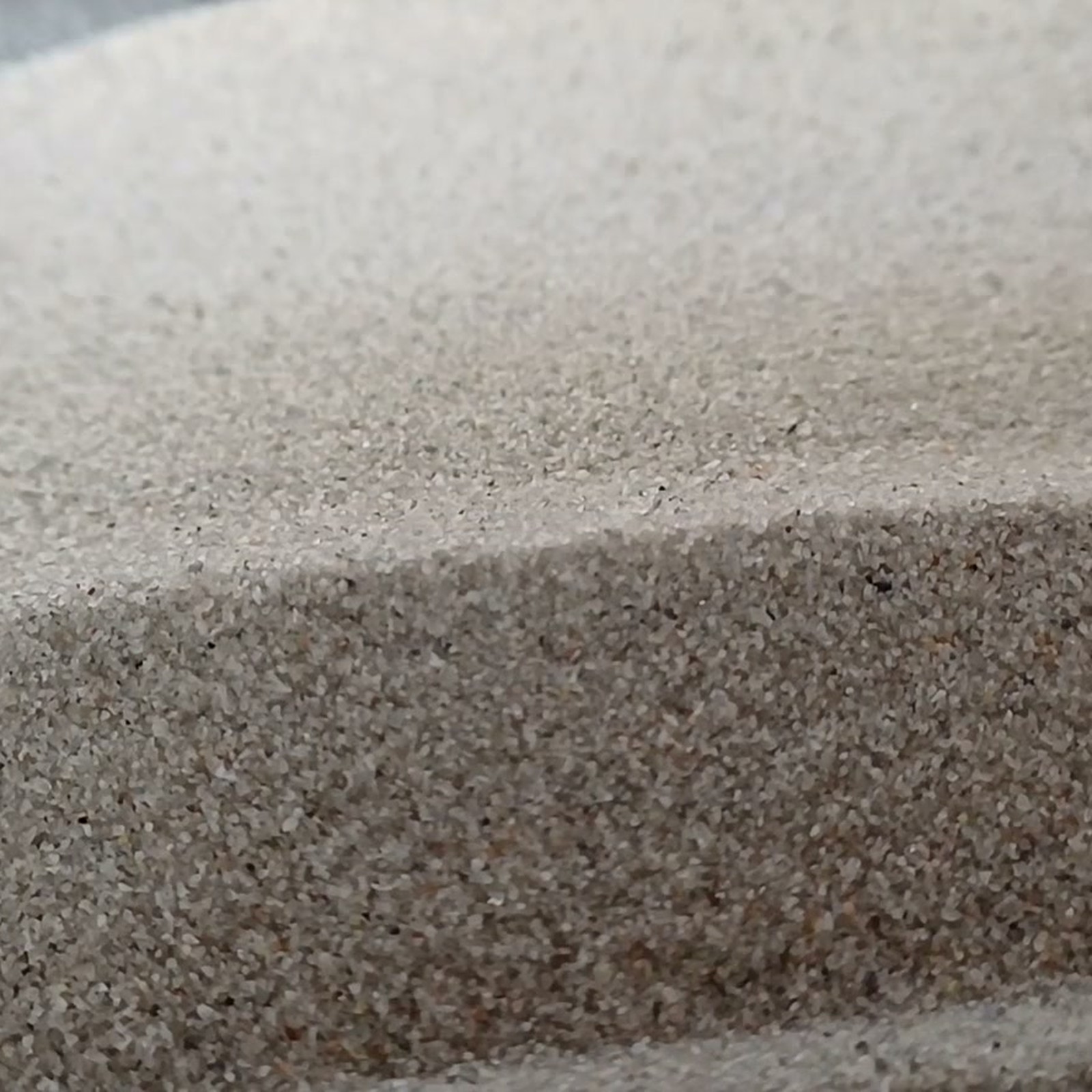Aquariumsand Naturgrau, 0,1–0,5 mm, 19 kg: Kornstruktur an einer geraden Vorderkante.